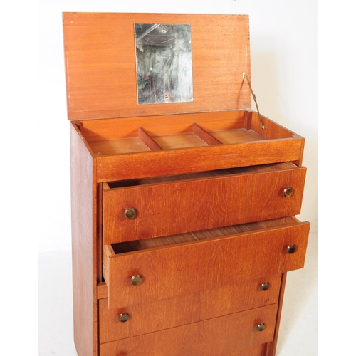 751 - British Modern Design - A mid 20th century teak veneered dressing chest of drawers. The chest of dra... 