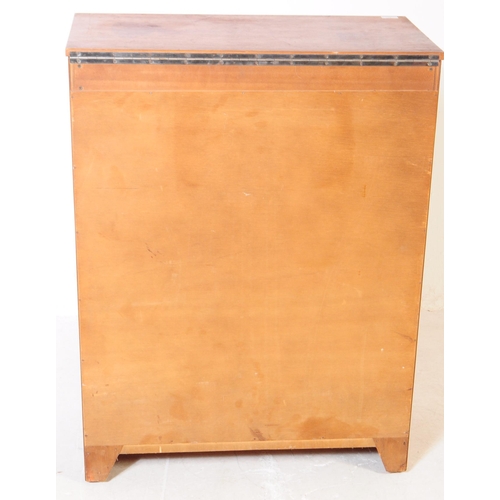 751 - British Modern Design - A mid 20th century teak veneered dressing chest of drawers. The chest of dra... 