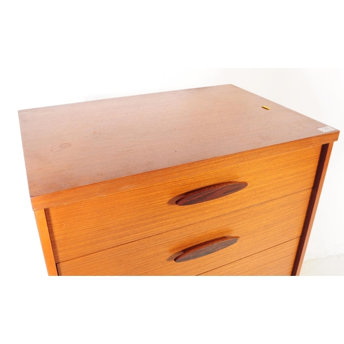 753 - British Modern Design - A mid 20th century teak tall boy chest of drawers. Rectangular form with a b... 