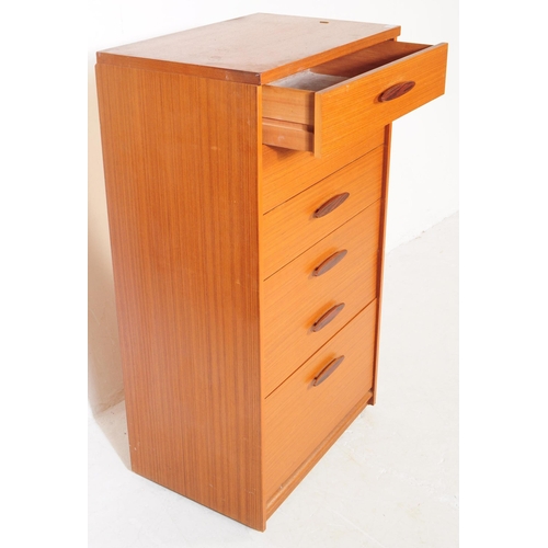 753 - British Modern Design - A mid 20th century teak tall boy chest of drawers. Rectangular form with a b... 