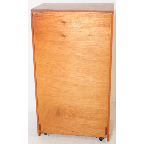 753 - British Modern Design - A mid 20th century teak tall boy chest of drawers. Rectangular form with a b... 