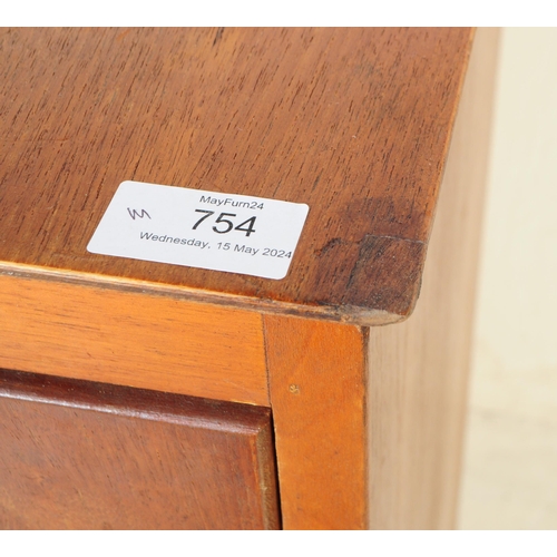 754 - British Modern Design - Mid century teak wood chest of drawers. Rectangular form with a bank of four... 