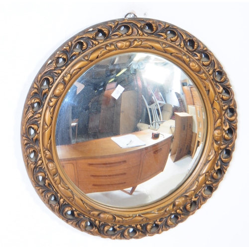 777 - A mid 20th century convex fisheye round mirror, in a gilt metal frame. Together with a later bevelle... 