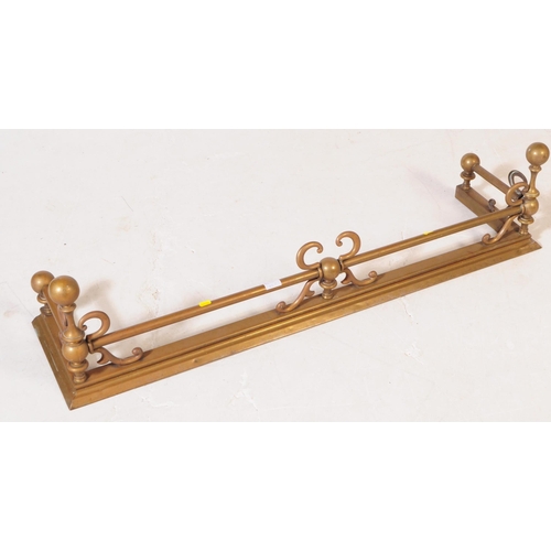 813 - Two early 20th century brass fireside fenders. Of rectangular pierced form, with foliate detail and ... 