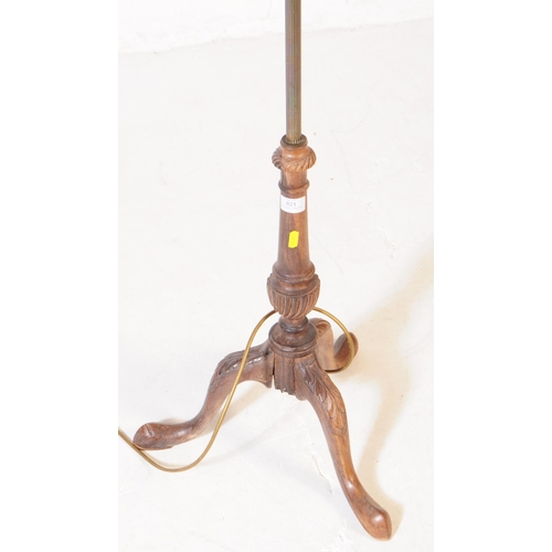 821 - An early 20th century brass and wood floor standing standard lamp. Having reeded central column into... 