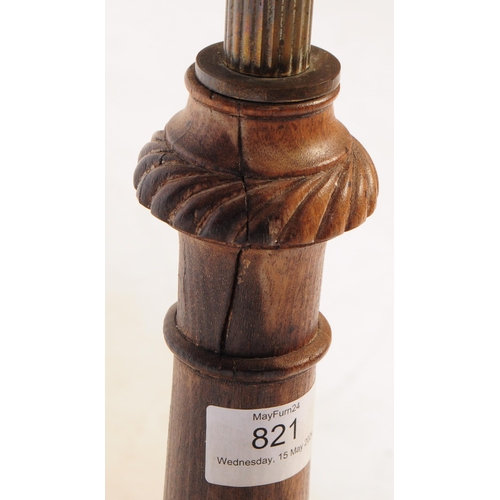 821 - An early 20th century brass and wood floor standing standard lamp. Having reeded central column into... 