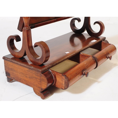 823 - A mid 19th Century Victorian mahogany toilet swing mirror. With turned supports on trestle legs upon... 