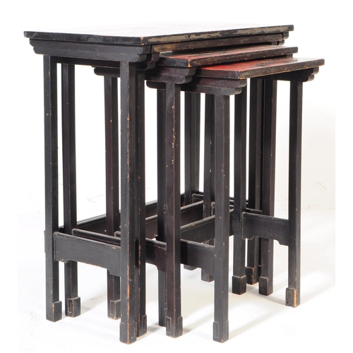 827 - A vintage 20th century red lacquered nest of tables. With Japanese scene to top, ebonised wood uprig... 