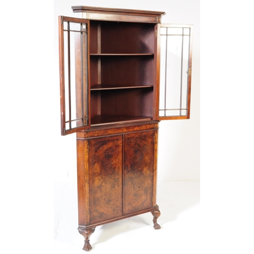 835 - A Queen Anne revival burr walnut veneer corner cabinet. Of triangular form with pediment top, twin a... 