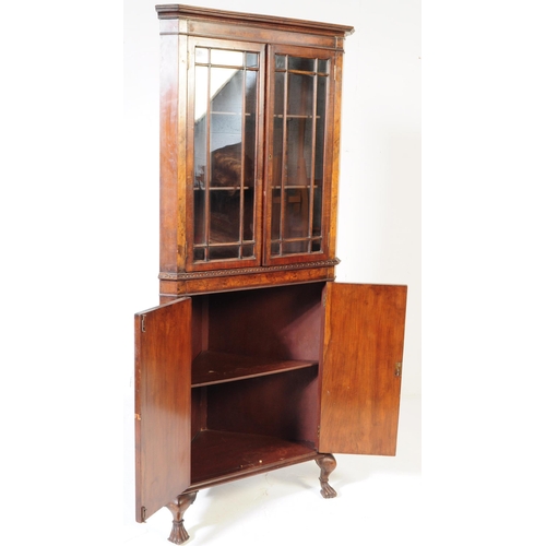 835 - A Queen Anne revival burr walnut veneer corner cabinet. Of triangular form with pediment top, twin a... 