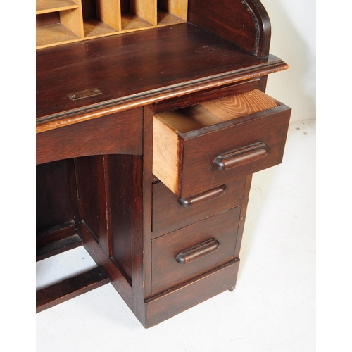 844 - An early 20th century mahogany roll top single pedestal writing desk. The desk raised on a single pe... 