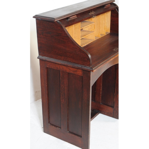 844 - An early 20th century mahogany roll top single pedestal writing desk. The desk raised on a single pe... 