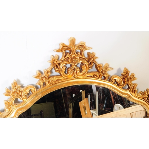 847 - A vintage 20th century reproduction French gilt overmantel boudoir mirror. Having ornate gilt frame ... 