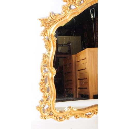 847 - A vintage 20th century reproduction French gilt overmantel boudoir mirror. Having ornate gilt frame ... 