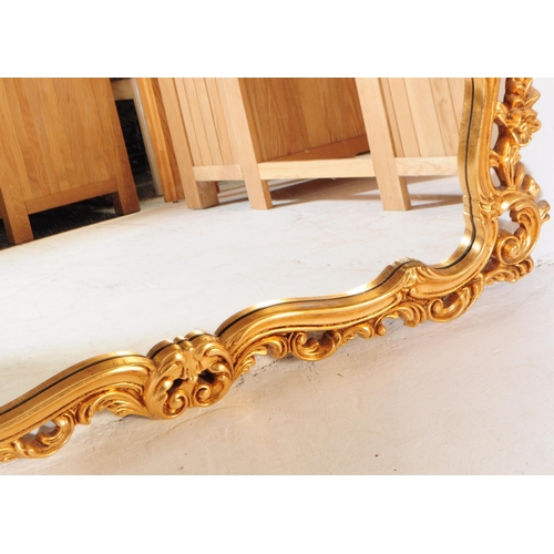 847 - A vintage 20th century reproduction French gilt overmantel boudoir mirror. Having ornate gilt frame ... 