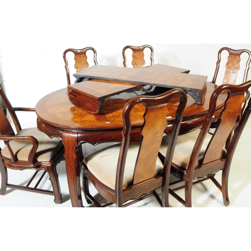 849 - A contemporary painted dining table with six chairs. Of oval form with extending capabilities. Figur... 