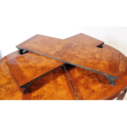 849 - A contemporary painted dining table with six chairs. Of oval form with extending capabilities. Figur... 