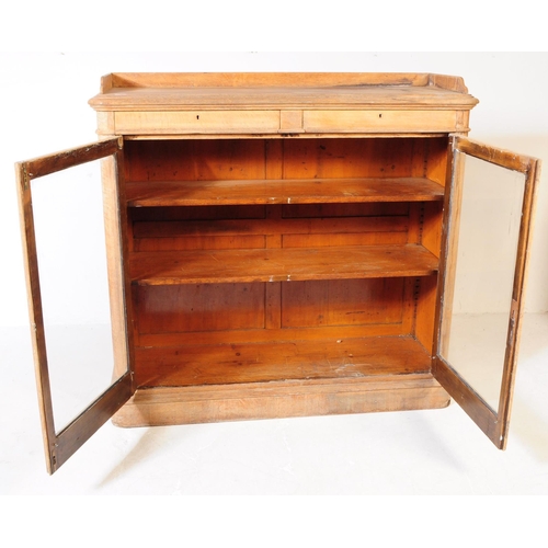 851 - A 19th century Victorian pine pier cupboard / library bookcase. The cabinet having two glazed doors ... 