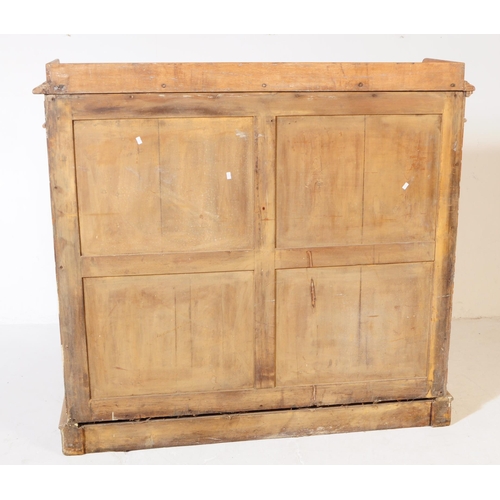 851 - A 19th century Victorian pine pier cupboard / library bookcase. The cabinet having two glazed doors ... 