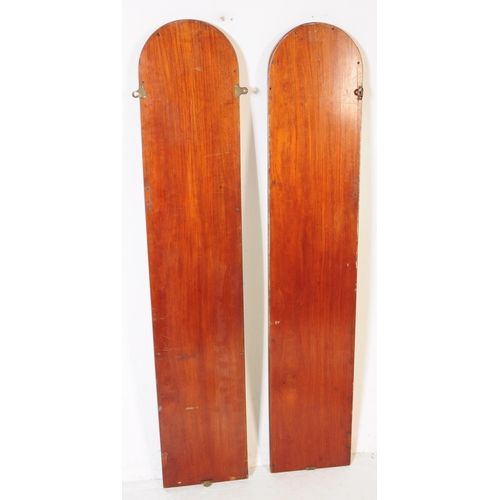 853 - A pair of early 20th circa 1920s arched ecclesiastical wall mirrors. The mirrors each of elongated a... 