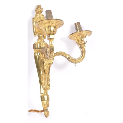 855 - A brass gilded twin branch wall sconce lights with golden ram head to body and vase shaped finial wi... 