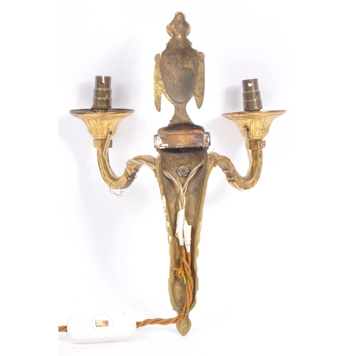 855 - A brass gilded twin branch wall sconce lights with golden ram head to body and vase shaped finial wi... 