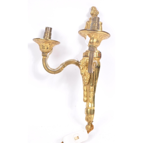 855 - A brass gilded twin branch wall sconce lights with golden ram head to body and vase shaped finial wi... 