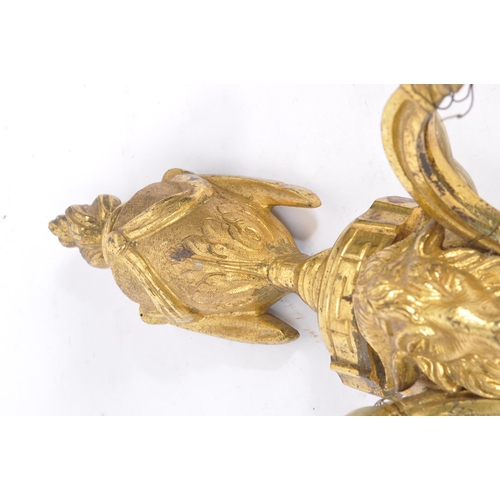 855 - A brass gilded twin branch wall sconce lights with golden ram head to body and vase shaped finial wi... 