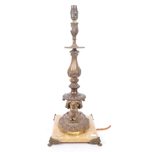 856 - A 19th Century French bronze lamp candlestick having floral and foliate design to sconce and column ... 