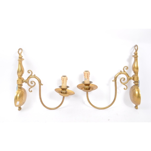 860 - A vintage mid 20th century circa 1940s Dutch brass wall sconces. Having a electrical light fixing wi... 