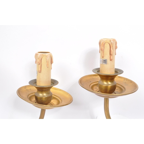 860 - A vintage mid 20th century circa 1940s Dutch brass wall sconces. Having a electrical light fixing wi... 