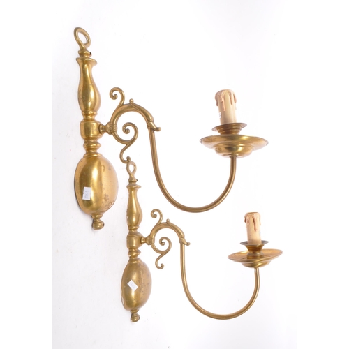 860 - A vintage mid 20th century circa 1940s Dutch brass wall sconces. Having a electrical light fixing wi... 