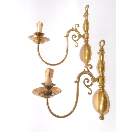 860 - A vintage mid 20th century circa 1940s Dutch brass wall sconces. Having a electrical light fixing wi... 