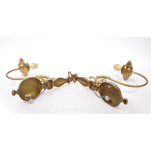 860 - A vintage mid 20th century circa 1940s Dutch brass wall sconces. Having a electrical light fixing wi... 