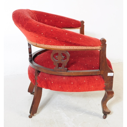 862 - An early 20th Century Edwardian mahogany upholstered smokers bow library armchair. The chair having ... 