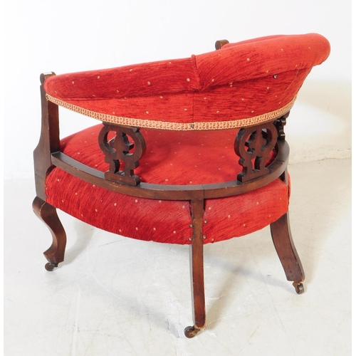 862 - An early 20th Century Edwardian mahogany upholstered smokers bow library armchair. The chair having ... 