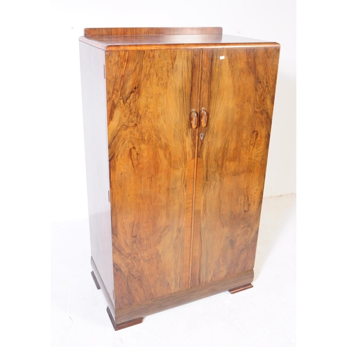 864 - An early 20th Century Art Deco circa 1920s walnut veneer bachelors wardrobe cupboard. The wardrobe r... 