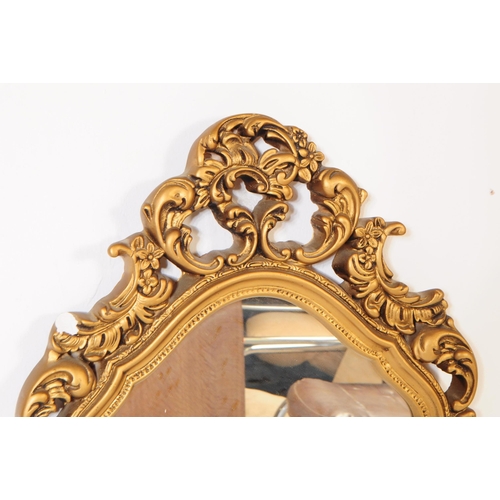 866 - Two Italian rococo manner giltwood and gesso framed wall mirrors. Each mirror featuring a carved roc... 