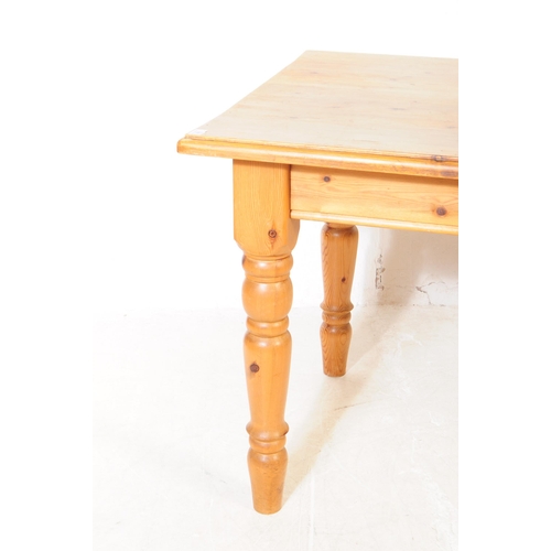 868 - A 20th century farmhouse country pine wood dining table and four chairs. The table raised on four tu... 