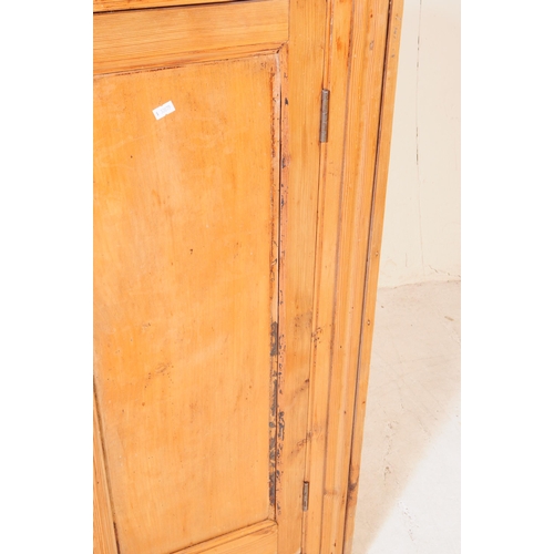 876 - A Victorian 19th century pitch pine school cupboard. Of rectangular form with flared top, twin woode... 