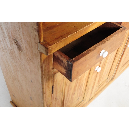 877 - A 19th century Victorian pine sideboard dresser. The sideboard raised on a plinth base below two cup... 