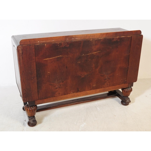 881 - A mid Century post war Jacobean revival oak sideboard credenza. The sideboard featuring twin doors t... 