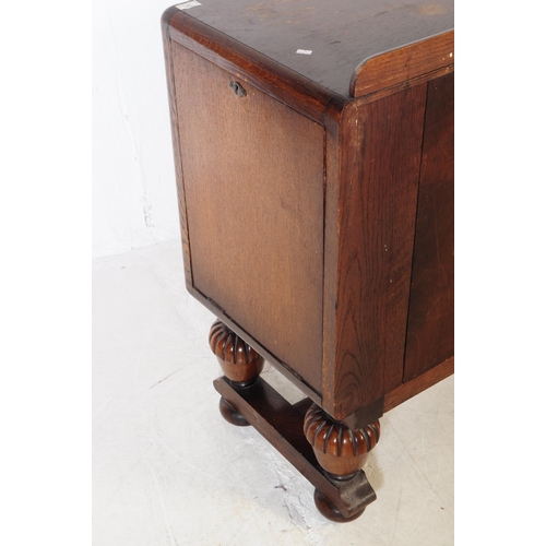 881 - A mid Century post war Jacobean revival oak sideboard credenza. The sideboard featuring twin doors t... 