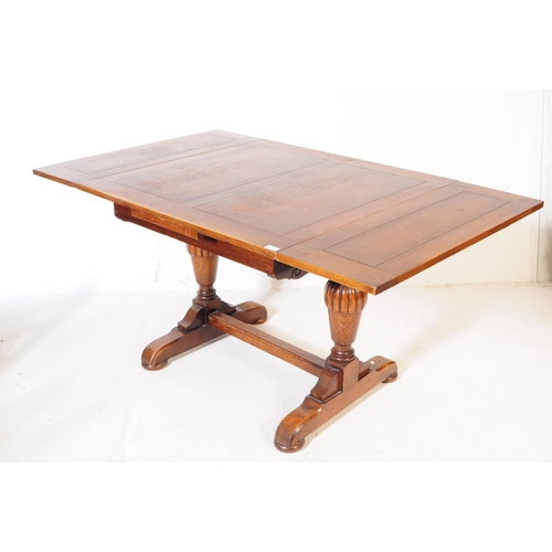 883 - A 20th century Jacobean revival oak cup and cover draw leaf dining table and six chairs. The table o... 