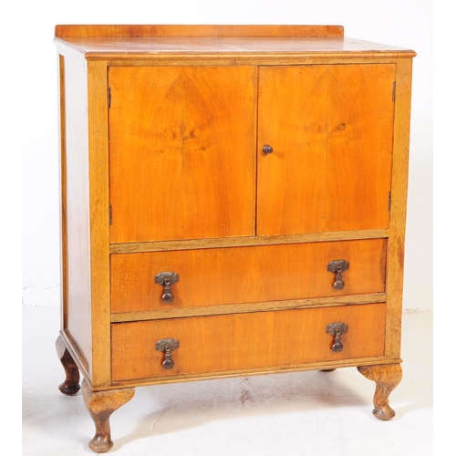 891 - An early 20th century circa. 1940s Queen Anne revival walnut veneer linen cupboard. Raised on cabrio... 