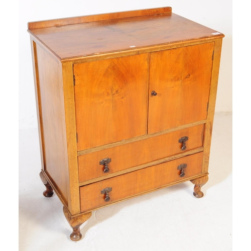 891 - An early 20th century circa. 1940s Queen Anne revival walnut veneer linen cupboard. Raised on cabrio... 