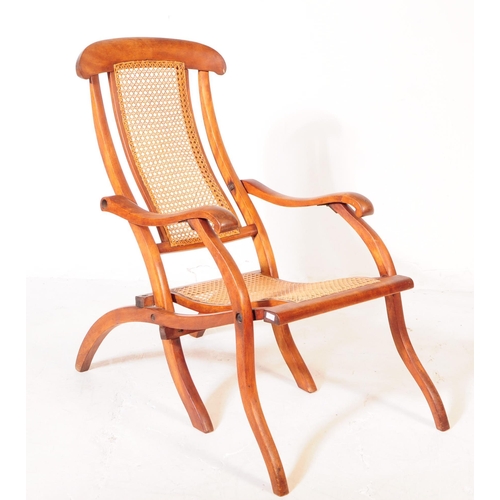 897 - A Victorian oak wood and rattan steamship cruise campaign folding deck chair. The chair featuring ra... 