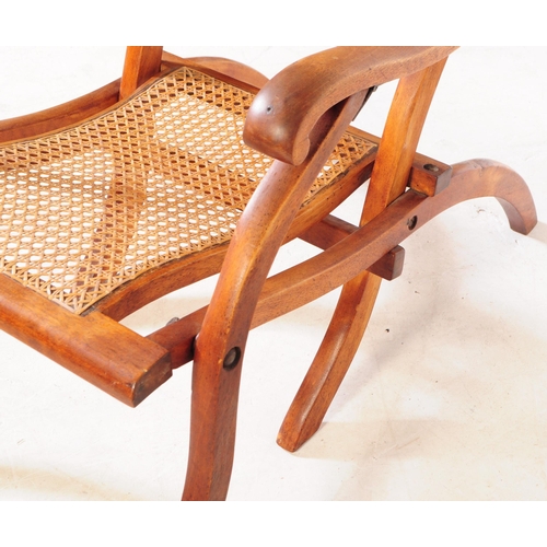 897 - A Victorian oak wood and rattan steamship cruise campaign folding deck chair. The chair featuring ra... 