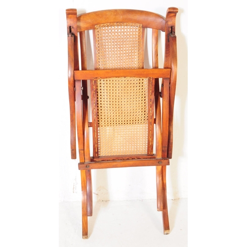 897 - A Victorian oak wood and rattan steamship cruise campaign folding deck chair. The chair featuring ra... 