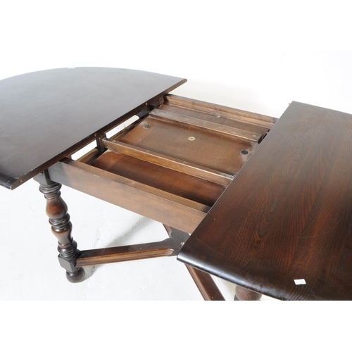 644 - Ercol - Model 705 - A 20th century Ercol Old Colonial elm wood model 705 dining table. The table rai... 